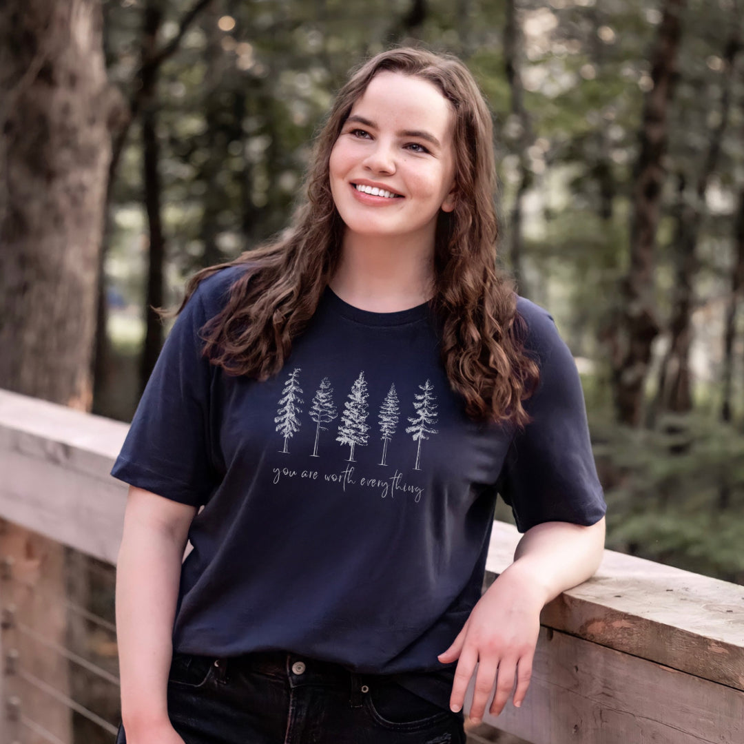 Adorned with beautiful enchanting winter pine trees graphic and the empowering affirmation message You Are Worth Everything, this Tshirt is a wearable reminder of your inherent value worth and uniqueness. Perfect gift for mom, advocate, social worker