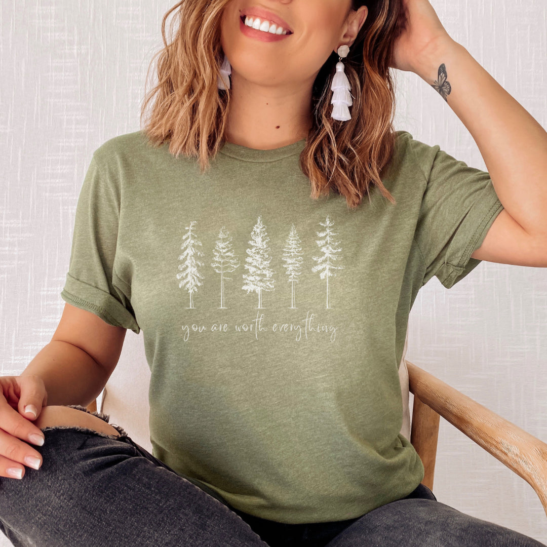Adorned with beautiful enchanting winter pine trees graphic and the empowering affirmation message You Are Worth Everything, this Tshirt is a wearable reminder of your inherent value worth and uniqueness. Perfect gift for mom, advocate, social worker