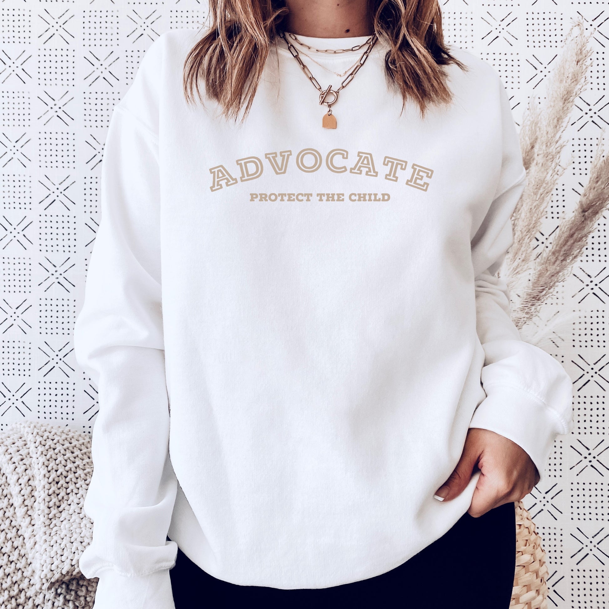 The front of the sweatshirt proudly displays the phrase "Advocate Protecct The Child" in a bold and eye-catching font. Crafted for child advocates and champions of children's mental health, and perfect for Child Abuse Awareness and Prevention Month!